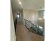 Carpeted staircase with black iron spindles and decorative chandelier at 27 Prency Ln, Middlesex, NC 27557
