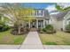Inviting blue two-story home with a charming front porch and meticulously landscaped front yard at 901 Wildflower Ridge Rd, Wake Forest, NC 27587