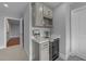 Elegant bar area with sleek cabinetry, wine cooler, and quartz countertop at 262 Hook Dr # 12, Fuquay Varina, NC 27526