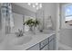 Bathroom features a double sink vanity, with white countertop, blue cabinetry and modern fixtures at 262 Hook Dr # 12, Fuquay Varina, NC 27526