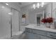 Bathroom featuring tiled walk-in shower, white vanity with light blue cabinets and white countertop with decorative elements at 262 Hook Dr # 12, Fuquay Varina, NC 27526