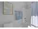 Bright bathroom featuring a shower with blue striped curtain, toilet, and tree art on the wall at 262 Hook Dr # 12, Fuquay Varina, NC 27526