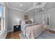 Bedroom with hardwood floors, neutral walls, large window, trey ceilings, and ensuite bathroom at 262 Hook Dr # 12, Fuquay Varina, NC 27526