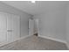 This bedroom features neutral walls and carpeting, with a double door closet and doorway to another room at 262 Hook Dr # 12, Fuquay Varina, NC 27526