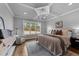 Bedroom boasts a tray ceiling, hardwood floors, a neutral color scheme, and a large window at 262 Hook Dr # 12, Fuquay Varina, NC 27526