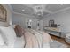 Comfortable bedroom with neutral walls, tray ceilings, hardwood floors, and ensuite bathroom at 262 Hook Dr # 12, Fuquay Varina, NC 27526