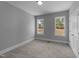 This bedroom offers neutral walls, plush carpeting, and natural light from two windows with backyard views at 262 Hook Dr # 12, Fuquay Varina, NC 27526