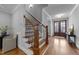 Beautiful entryway featuring a wood staircase with iron spindles and a wood and glass front door at 262 Hook Dr # 12, Fuquay Varina, NC 27526