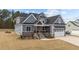 Charming two-story home featuring a stylish gray exterior, stone accents, and an inviting front porch at 262 Hook Dr # 12, Fuquay Varina, NC 27526