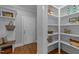 Inviting hallway featuring a built-in bench, storage shelves, and hardwood flooring at 262 Hook Dr # 12, Fuquay Varina, NC 27526