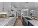 Kitchen features white cabinets, gold hardware, stainless steel appliances, and hardwood floors at 262 Hook Dr # 12, Fuquay Varina, NC 27526