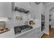 Close-up of a modern range with a pot filler, marble backsplash, and white cabinets at 262 Hook Dr # 12, Fuquay Varina, NC 27526