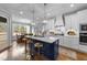 Bright kitchen featuring white cabinets, a blue island with seating, and stainless steel appliances at 262 Hook Dr # 12, Fuquay Varina, NC 27526