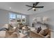 Bright living room features large windows, plush seating, and a modern ceiling fan at 262 Hook Dr # 12, Fuquay Varina, NC 27526