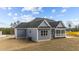 Back of home features blue siding, black roof, and a screened porch at 262 Hook Dr # 12, Fuquay Varina, NC 27526