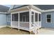 Charming screened-in porch with white railing and wood steps at 262 Hook Dr # 12, Fuquay Varina, NC 27526