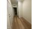 Hardwood floor hallway with access to other rooms at 150 Sawtooth Oak Lane, Youngsville, NC 27596