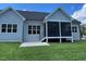 Backyard showcasing a spacious screened porch, perfect for relaxing and entertaining at 100 Old Garden Ln, Youngsville, NC 27596