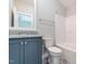 Modern bathroom with granite counters, sleek gray cabinets, and a tiled floor at 100 Old Garden Ln, Youngsville, NC 27596