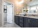 Bathroom with double vanity, granite countertops, modern fixtures, and a view of the tiled shower at 100 Old Garden Ln, Youngsville, NC 27596
