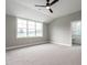 Neutral bedroom with carpet, ceiling fan, and a window overlooking the lawn at 100 Old Garden Ln, Youngsville, NC 27596