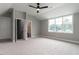 Spacious bedroom with large windows, ceiling fan, and adjoining bathroom and closet at 100 Old Garden Ln, Youngsville, NC 27596