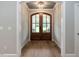 Inviting entryway with arched doorway, double glass doors and wood floors at 100 Old Garden Ln, Youngsville, NC 27596