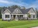 Beautiful single-story home with a stone facade, shutters, and a well-manicured lawn at 100 Old Garden Ln, Youngsville, NC 27596