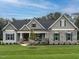 Charming home with stone accents, symmetrical design, and a welcoming front porch at 100 Old Garden Ln, Youngsville, NC 27596