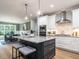 Stylish kitchen featuring a granite island, stainless steel appliances, and a view into the dining area at 100 Old Garden Ln, Youngsville, NC 27596