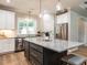 Well-equipped kitchen with stainless steel appliances, large island and white cabinets at 100 Old Garden Ln, Youngsville, NC 27596