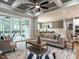 Bright living room with coffered ceilings, sliding doors to the outside and comfortable furniture at 100 Old Garden Ln, Youngsville, NC 27596