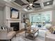 Cozy living room featuring a fireplace, built-in shelves and access to a screened in porch at 100 Old Garden Ln, Youngsville, NC 27596