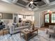 Cozy living room with coffered ceilings, fireplace and arched doorways at 100 Old Garden Ln, Youngsville, NC 27596