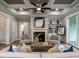 Cozy living room featuring a fireplace, built-in shelves and coffered ceilings at 100 Old Garden Ln, Youngsville, NC 27596