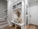 Functional mudroom with built-in storage, a bench, and hooks, perfect for organizing entryway essentials at 100 Old Garden Ln, Youngsville, NC 27596