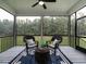 Inviting screened-in porch with comfortable seating, perfect for enjoying the outdoors at 100 Old Garden Ln, Youngsville, NC 27596