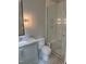 Modern bathroom featuring gray vanity, glass shower, and decorative lighting at 2227 Wheeler Rd, Raleigh, NC 27607