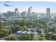 Aerial view of townhomes set against the backdrop of a city skyline and lush greenery at 2 Seawell Ave # 101, Raleigh, NC 27601