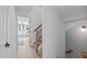 Hallway with stairs leading to the next level and view to light-filled sunroom at 2 Seawell Ave # 101, Raleigh, NC 27601