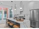 Bright kitchen with white cabinets, large marble island, pendant lighting, and stainless steel appliances at 2 Seawell Ave # 101, Raleigh, NC 27601