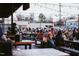 People gather on wooden benches at picnic tables under string lights at this relaxed outdoor venue at 2014 Moody Ln, Durham, NC 27701