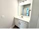 Well-lit powder room features a modern vanity, sink, and a sleek mirror for convenience at 152 Southern Estates Dr, Sanford, NC 27330