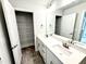 Modern bathroom with double sink vanity, large mirror, and spacious storage closet at 152 Southern Estates Dr, Sanford, NC 27330