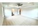 Large bedroom with tray ceiling, recessed lighting, ceiling fan, and doorways to bathroom and closet at 152 Southern Estates Dr, Sanford, NC 27330