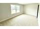 Carpeted bedroom with large window and neutral paint at 152 Southern Estates Dr, Sanford, NC 27330