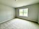 Cozy bedroom with neutral carpet, a window providing natural light, and a calming ambiance at 152 Southern Estates Dr, Sanford, NC 27330