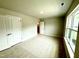 Spacious bedroom featuring neutral walls, carpeted floors, and natural light from a large window at 152 Southern Estates Dr, Sanford, NC 27330