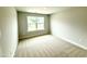 Bright bedroom with large window, neutral carpet, and light walls, perfect for relaxation at 152 Southern Estates Dr, Sanford, NC 27330