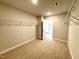 Walk-in closet with carpet, wire shelving, and doorway to the bedroom at 152 Southern Estates Dr, Sanford, NC 27330